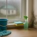Cleaning mold from a damp window sill in an Australian home during monsoon season