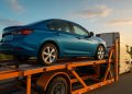 Enclosed car being loaded onto a transport trailer for safe and easy vehicle shipping