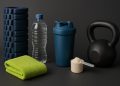 Fitness gear, water bottle, towel, and healthy snacks arranged for post-workout recovery tips