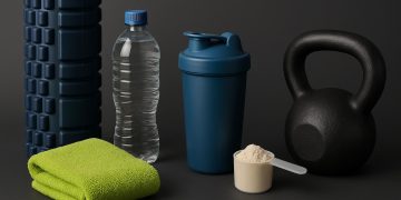Fitness gear, water bottle, towel, and healthy snacks arranged for post-workout recovery tips