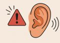 Close-up of an ear with warning icons highlighting potential hearing health issues